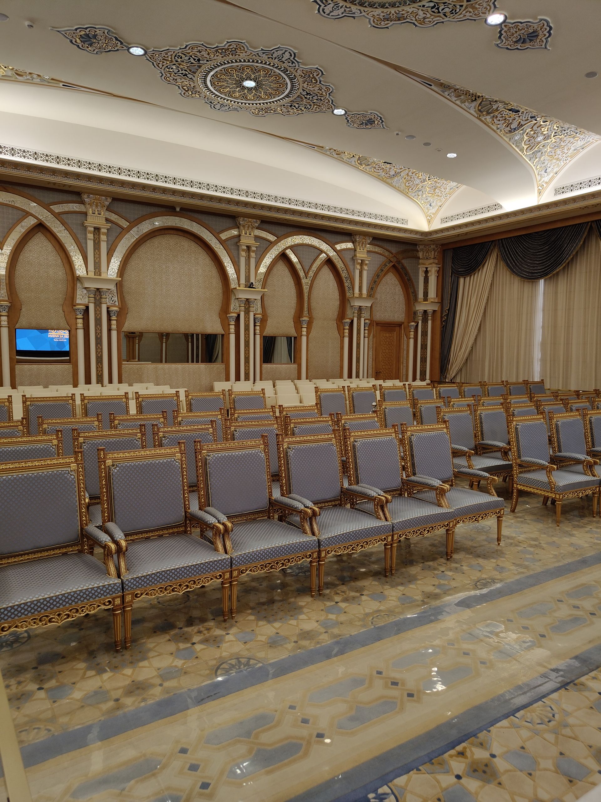 Luxurious conference hall with ornate architecture and elegant seating in Abu Dhabi.